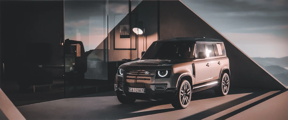 Defender — front three-quarter view in a sunlit interior